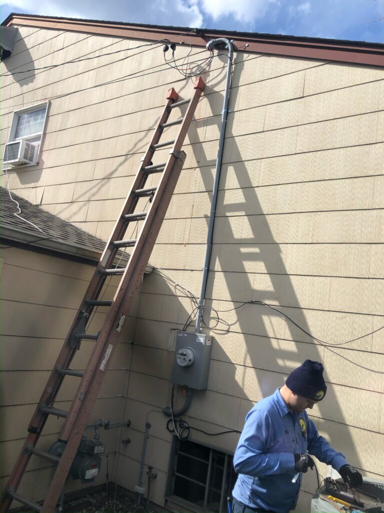 ladder on the side of a house. outdoor electrical being installed.