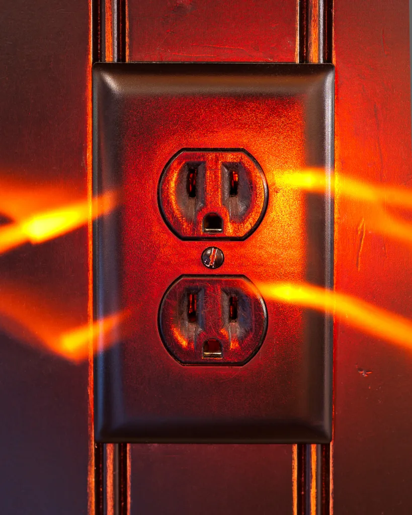 An outlet with streaks of fire emitting from the sides showing energy.