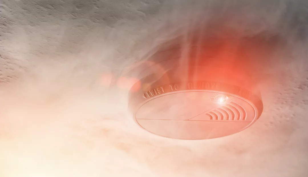 Smoke detector mounted on roof in apartment