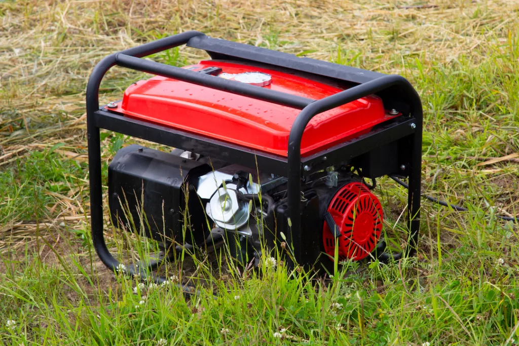 A gasoline generator is used in the forest to generate electricity.