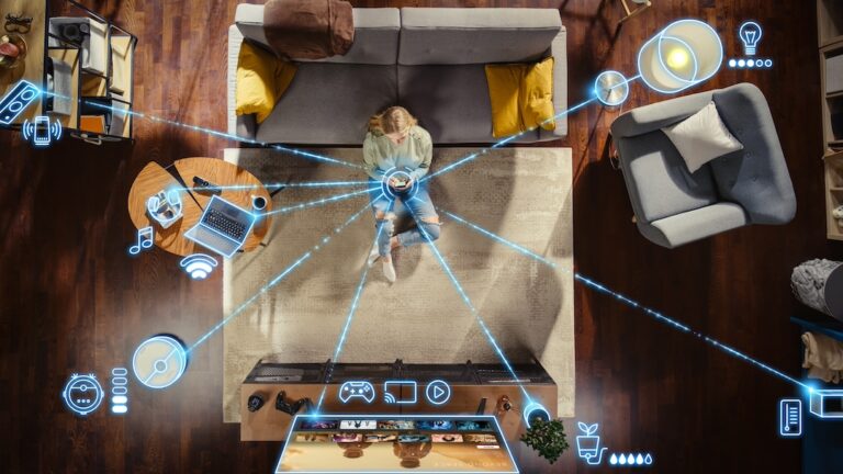 Top View Of Woman In the Loft Apartment Sitting On Carpet Next To Couch and Connecting Smartphone to Smart Home System.