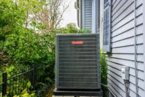 New Goodman air conditioning unit on side of historic home