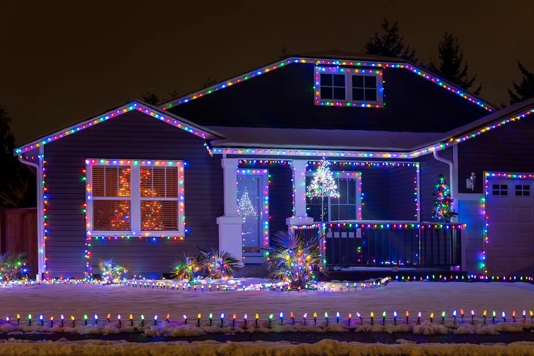 Beautiful Christmas decorations outside the house at night. House decorated with blue lights for Christmas. Selective focus, blurred background